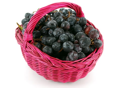 Basket with grapes isolated on white