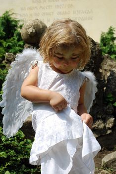 Little white angel child outdoor scene