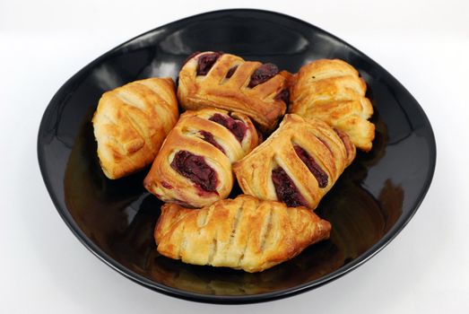 Sweet croissant with cherry on white