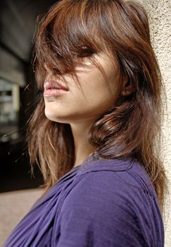 brown hair on the eyes of beautiful city woman