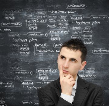 Young man thinking at a business plan