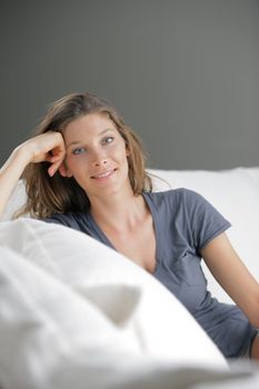 Portrait of beautiful young woman relaxing on couch 