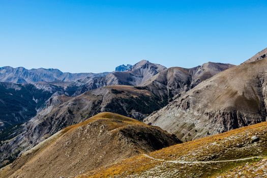 Beautiful landscape at high altitude in the Southern Franch Alps with a small footpath in the bottom of the image.