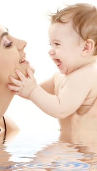 picture of happy mother with baby boy in water