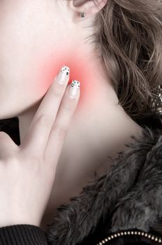 Woman checking her heart heart rate holding her fingers to her neck