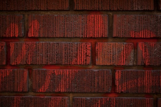 Red brick wall with writing