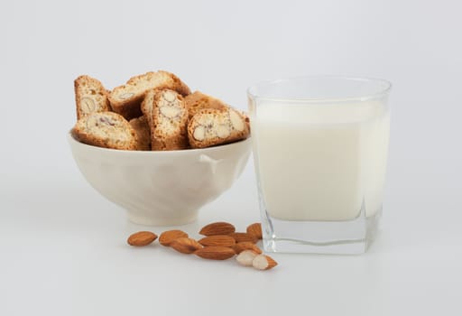 Almond biscottis and milk on a white background