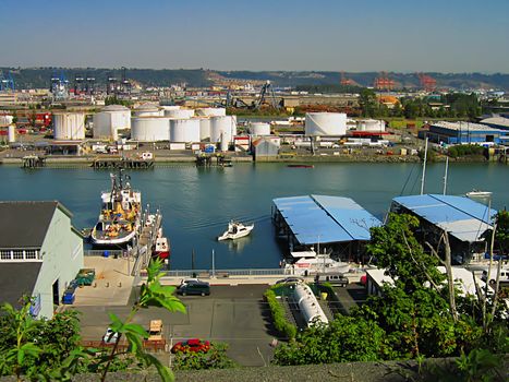 A photograph of an urban manufacturing and commerce area located near a waterway.