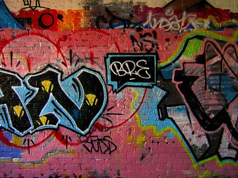 A photograph of graffiti on the side of an abandoned building.