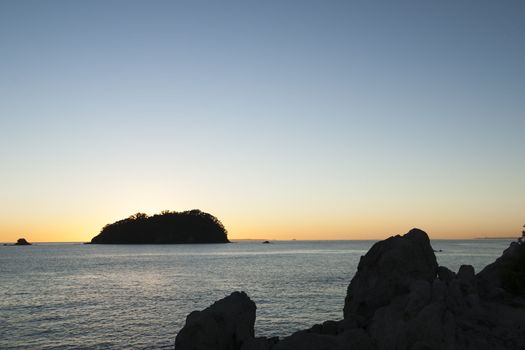 Sunset silhouette over leisure island, Mount Maunganui.