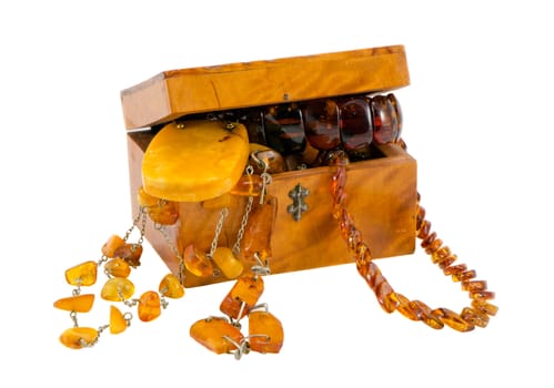 Amber jewelry in vintage wooden box chest isolated on white background
