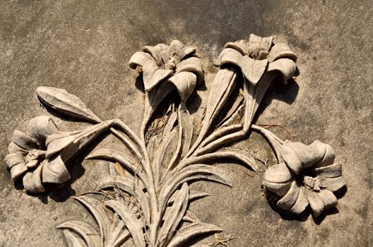 Close up of carved stone lily flowers and stems