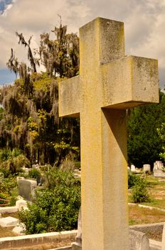 A large cross memorial rises above the headstones in this cemetery