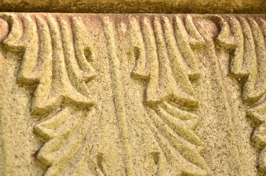 Close up of scrolling leaf design on an old monument