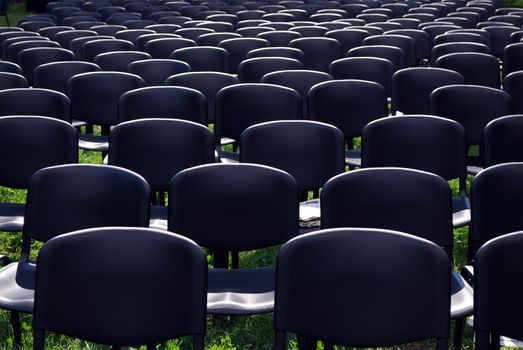 Black plastic chairs in line