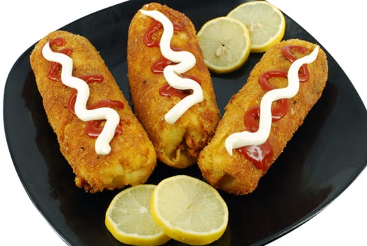 Fried salt pancake with lemon on dish