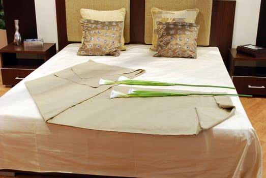 Bedroom with calla lily flower on bed