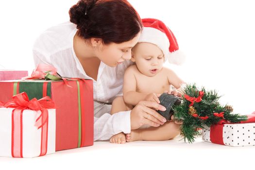 baby and mother with christmas gifts over white (focus on baby)