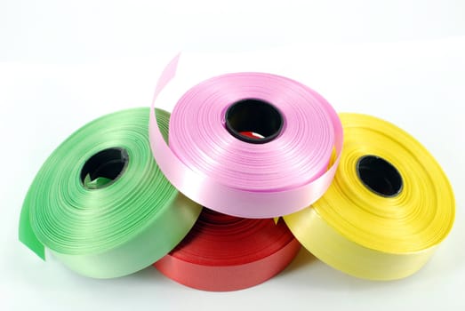 Multicolored ribbons on white background