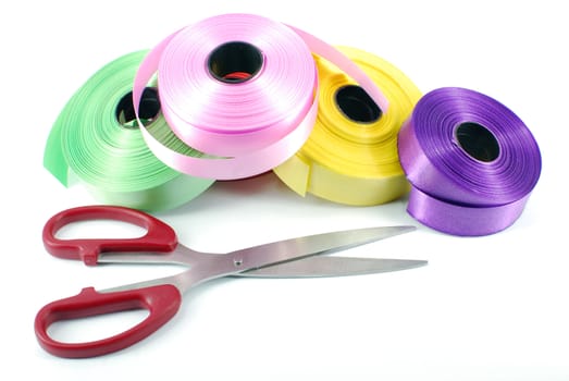 Scissors and ribbons on white