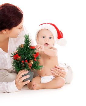baby and mother with christmas gifts over white