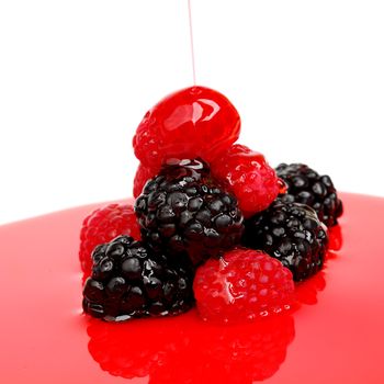 berry mixed pile in syrup isolated on white