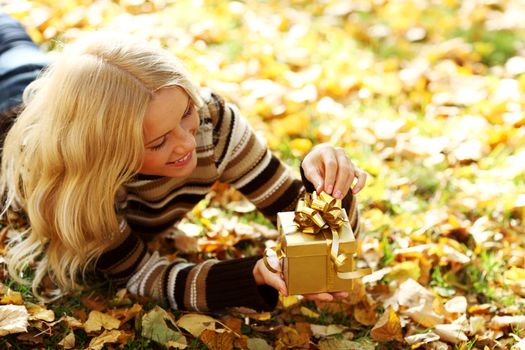 woman take autumn gift in park