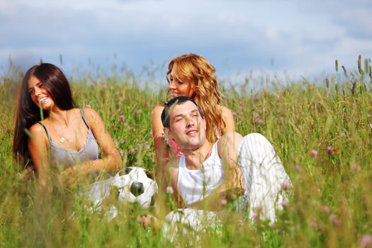 friends and dog in green grass field