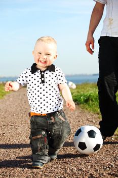 little boy play soccer outdoor