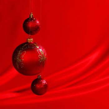  christmas balls on red satin background
