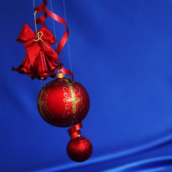 red christmas balls on blue satin background