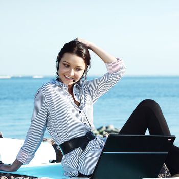 woman with laptop sea background