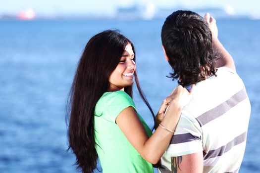 man and woman hug in the sky sea on background