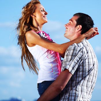 man and woman hug in the sky and sea on sea