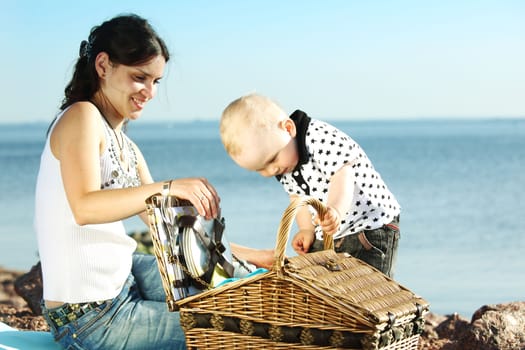 happy mother and son on picnic near sea