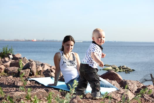 happy mother and son on picnic near sea