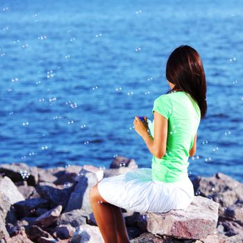 woman relax blue sea and bubbles on background