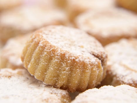 Cupcakes with icing sugar, in a pile, macro