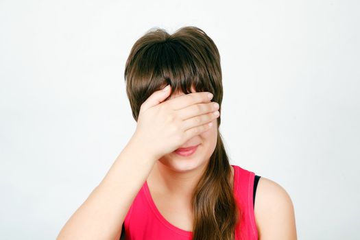 Teen girl hides her face in his hand