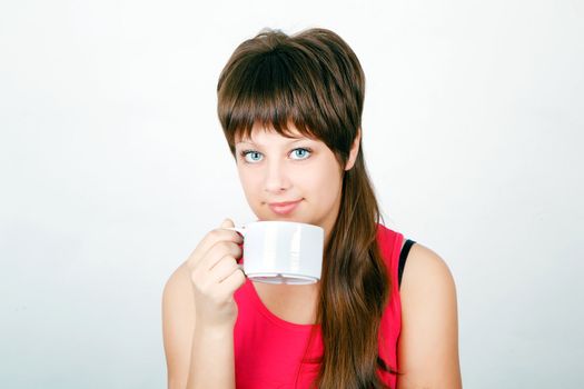 blue-eyed teen girl with a big white mug