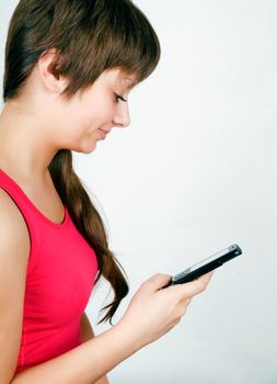 teen girl with a mobile phone reads the message