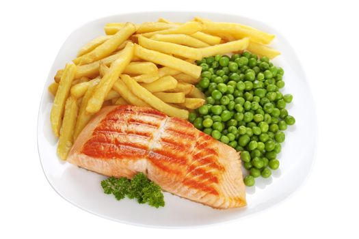 Grilled salmon steak on a white plate with chips and peas.