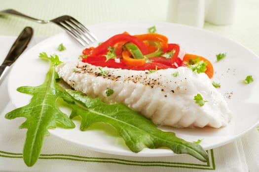 A simple dinner of baked fish with stir fried capsicums.