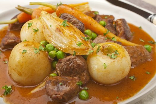 A French dish, navarin of lamb is a lamb stew with root vegetables, often served at Easter. It contains turnips, carrots, potatoes, onions and peas, in a thick glossy sauce. Enjoy it with French bread and red wine!