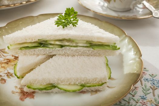 Soft white bread with the crusts removed, spread with mayonnaise and sandwiched with plenty of thinly sliced cucumber, served up on an old fashioned tea set, makes for a nostalgic treat!