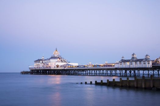 The pier at Eastbourne, Sussex, illuminated at twilight on a perfectly clear summer evening.