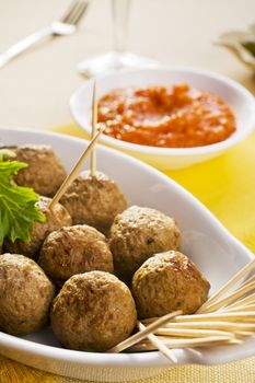 Spanish tapas, albondigas or meatballs, with spicy dipping sauce.