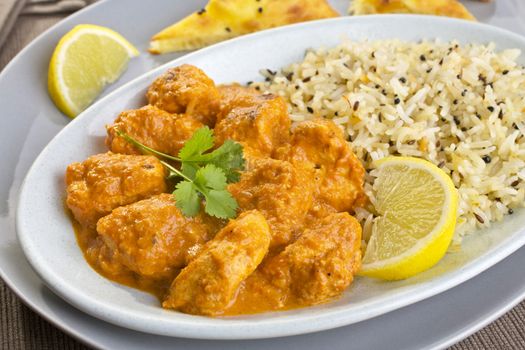 An Indian meal of chicken tikka masala and pilau rice, with naan bread on the side. Britain's favourite curry, more popular than fish and chips,
