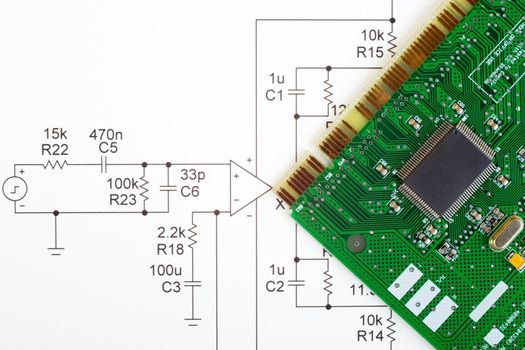 Electronic circuit diagram and electronic circuit board. Concepts of technology and direction. These two do not belong together - the diagram is an amplifier,the board is a sound card.