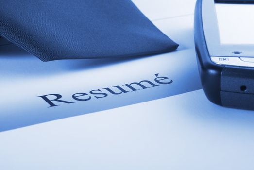 Resume with PDA and necktie, ready for job interview, blue tone. More recruitment:-